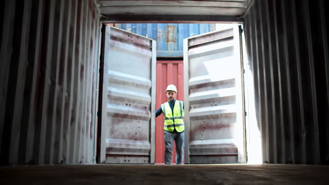 Dock worker opening a shipping container