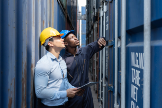 Two people inspecting a shipping container